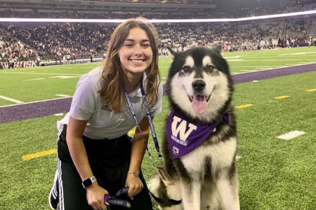 Michelle Harte posing with Dubs the husky dog