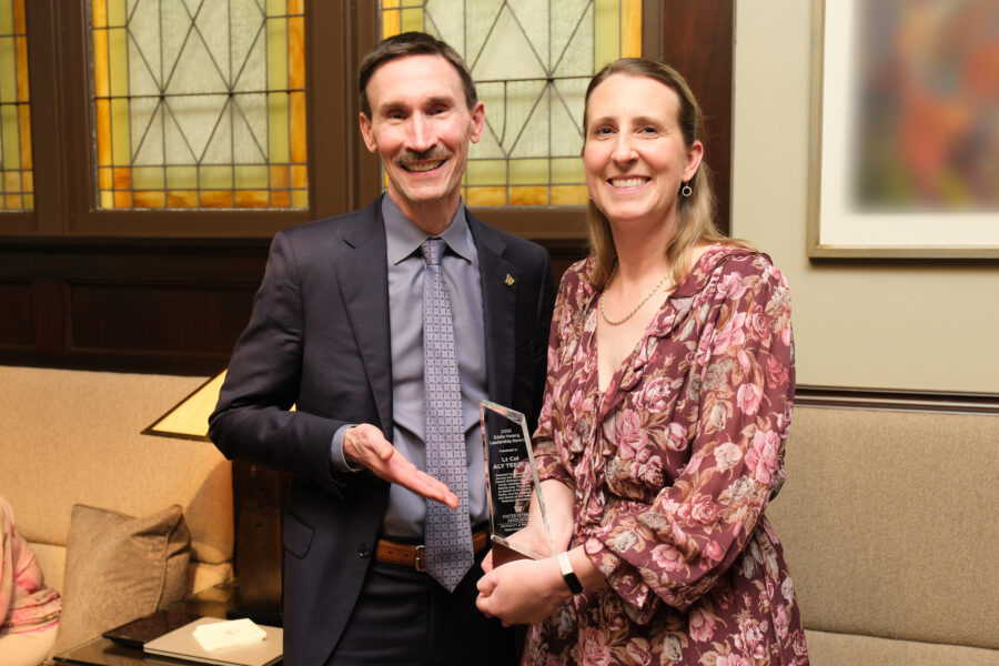 Retired U.S. Air Force Lieutenant Colonel and the 2026 EHALA recipient, Aly Teeter, posing with Foster School of Business Dean Frank Hodge. 