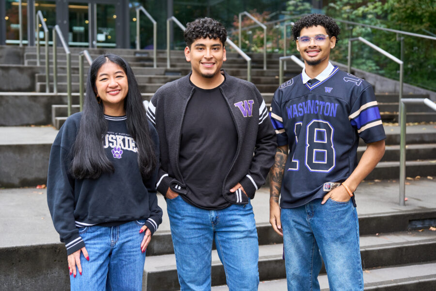 Krisanta Bolante (left) posing with fellow students wearing University of Washington merch.