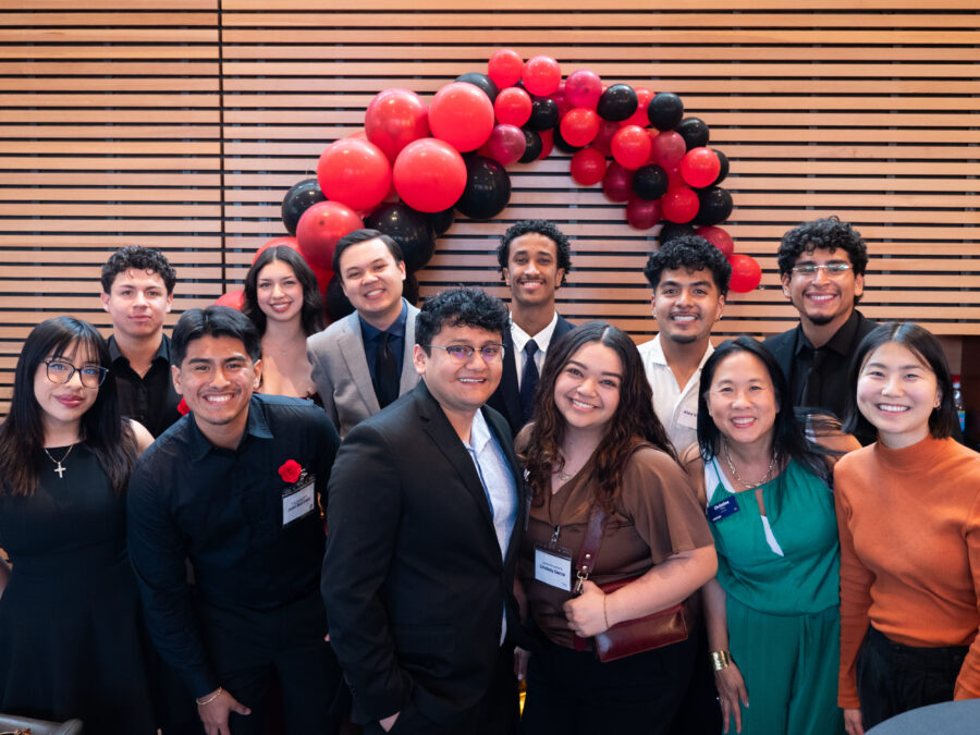 Lindsay Garza (front row, third from right) returns to campus as an alum to support students at the end-of-year Latine Celebration. 
