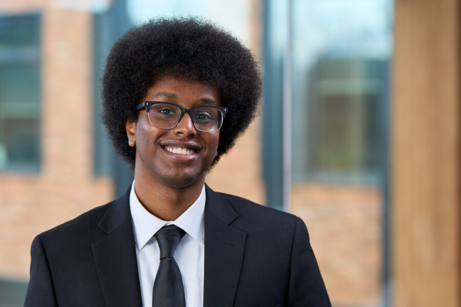 Jibril Ali-Halane, 2025 Poets&Quants Best & Brightest Undergraduate Business Majors, posing at Founders Hall.