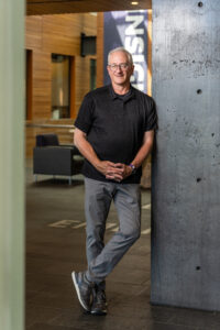 David Cordova, Foster alumni, posing at Paccar Hall