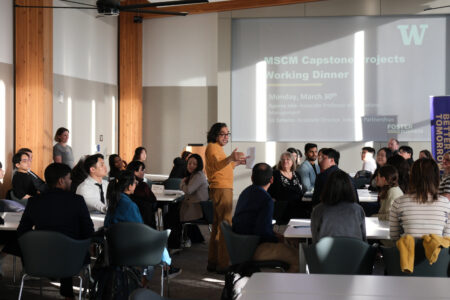 Foster Professor Apurva Jain presenting to a group of graduate students and local business leaders at the Master of Supply Chain Management Capstone Project Working Dinner