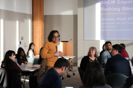 Foster Professor Apurva Jain presenting to a group of graduate students and local business leaders at the Master of Supply Chain Management Capstone Project Working Dinner