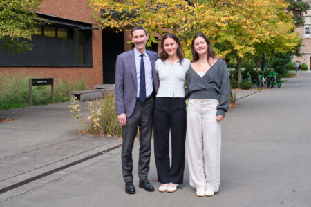 Amanda and Hana Moll posing with Foster School of Business Dean Frank Hodge as they return to the Seattle campus